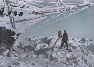 Hurley photographing under the bows of the "Endurance", British Imperial Trans-Antarctic Expedition, 1914-1917, by Frank Hurley